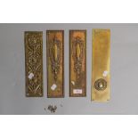 Four early 20th century brass door finger plates, one having floral embossed pattern, two with