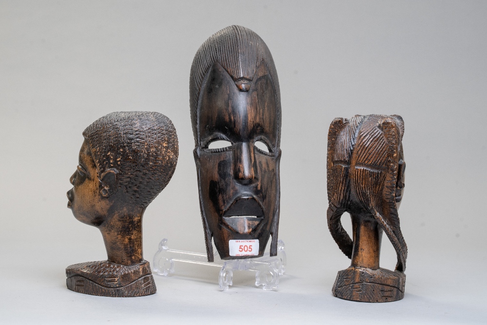 A pair of African tribal heads carved in heavy ethnic woods and a carved wall mounted mask. - Image 2 of 2