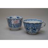 A Chinese export hard paste tea bowl having six hand decorated panels with floral and butterfly /