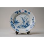 A late 18th century blue and white wear English delft plate decorated with a Chinoiserie style