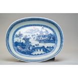 An antique hard paste Chinese export serving dish or charger having a hand decorated blue and