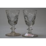 A pair of Victorian toastmasters glasses having cut panels to the bowls and central knop to the