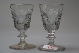 A pair of Victorian toastmasters glasses having cut panels to the bowls and central knop to the