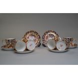 Six Royal Crown Derby coffee cans and saucers in the Imari palette,all in good order with some