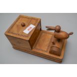 A 20th century cigarette smokers mechanical dispenser having a light mahogany outer case with