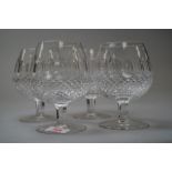 A set of four Waterford brandy glasses with hobnail and cut panels to the bowls.