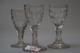 A pair of Toastmasters glasses with cut panels to bowl and stem and a similar glass.