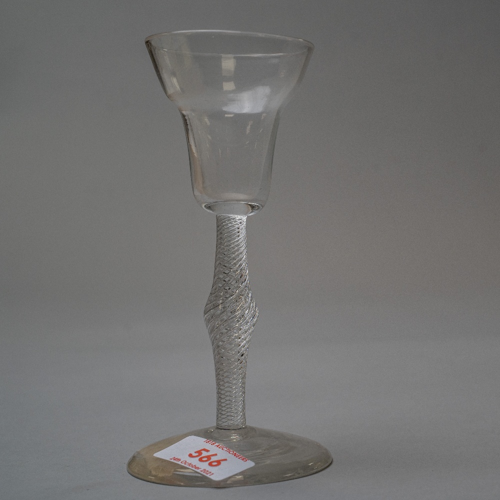 A wine glass, circa 1750 on plain foot with air twist stem central knop and ogee bowl.