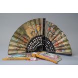 Four vintage fans including two early 20th century paper fans with Spanish scenes.