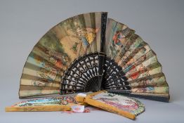 Four vintage fans including two early 20th century paper fans with Spanish scenes.