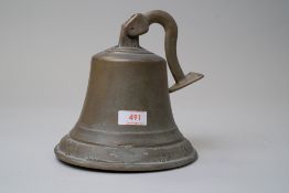 A large vintage wall mounted brass bell having floral pattern to edge.