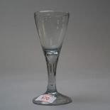 A wine glass with domed and folded foot with plain stem and elongated tear with plain bowl mid