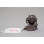 A traditional Japanese Netsuke or Netsky of a Demon or Oni carved in an exotic hardwood and