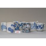 Seven blue and white wear antique tea or coffee cups in various designs including hard paste and