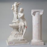 A classical styled figure base of a semi nude bather at a water fountain cast in resin standing 67cm