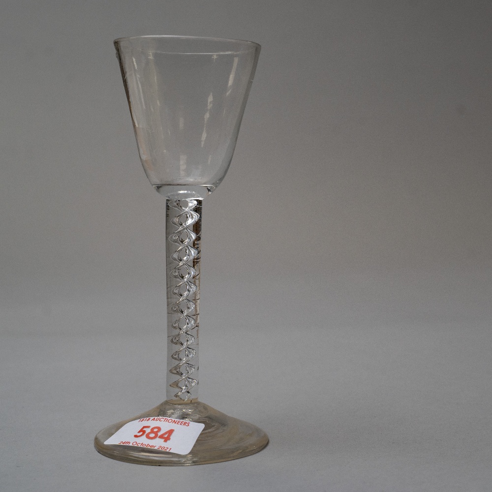 A mid 18th century wine glass with air twist stem