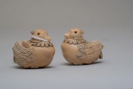 A pair of ornately carved Japanese netsuke of a male and female duck carved in animal horn and