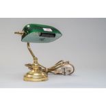 A small bankers style desk top lamp having brass base and bottle green shade.