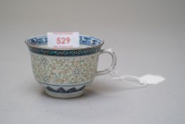 A hard paste Chinese export tea cup highly decorated with phoenix motif in base of cup with rice