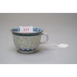 A hard paste Chinese export tea cup highly decorated with phoenix motif in base of cup with rice