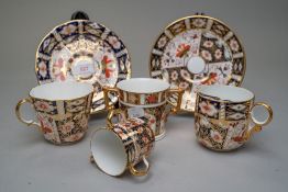 Four Royal Crown Derby cups in traditional Imari designs including moustache cup and saucer, a small