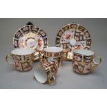 Four Royal Crown Derby cups in traditional Imari designs including moustache cup and saucer, a small