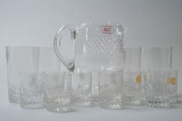 A selection of glassware including a water jug and four tumblers also nine smaller glasses, some