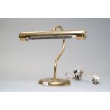 A large brass bankers style desk lamp.