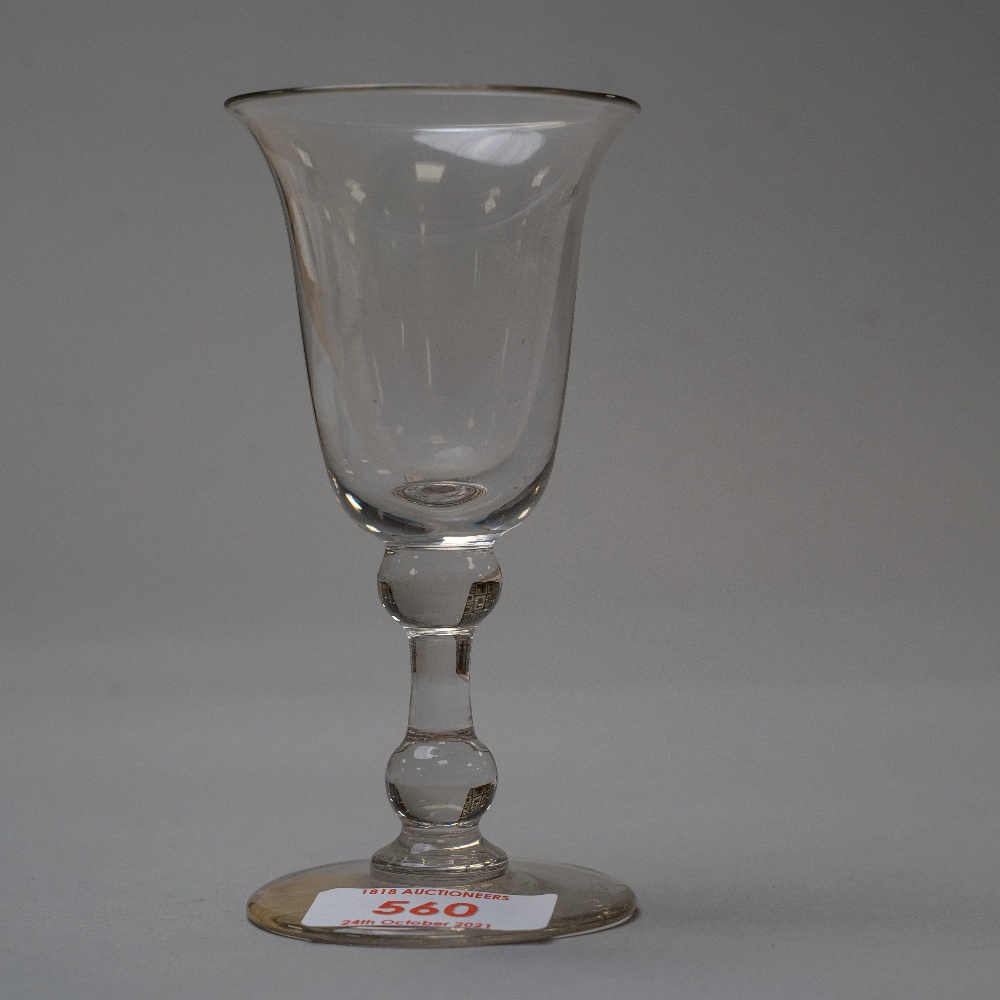 A deep bowl wine glass with two knops to stem.