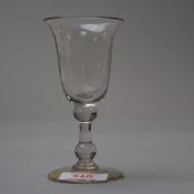 A deep bowl wine glass with two knops to stem.