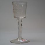 A wine or ale glass having a plain foot with a white twist stem standing 16.8cm tall and having