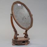 A fine antique Georgian mirror having swivel drawer base with scroll work supports and silver backed