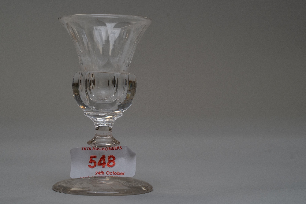 A small sherry glass having thistle shaped bowl.