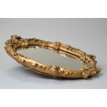 A vintage mirror with an elaborate plaster cast and gilt frame