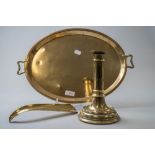 A vintage oval brass tray having handles to sides, a brass shoe horn and a brass candle stick