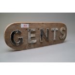 A vintage municipal or public toilet door sign for gents in lead lettering and partially painted