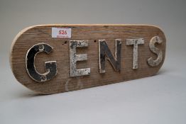 A vintage municipal or public toilet door sign for gents in lead lettering and partially painted