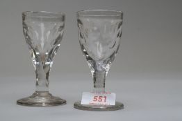 Two small toastmasters glasses having cut circles to bowls.