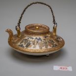 A Japanese saki or tea pot of squat form in a traditional Satsuma ware palette, highly decorated