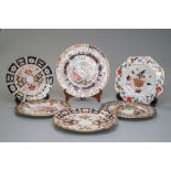 Six Royal Crown Derby plates, all of which are slightly different but all are in the Imari palette.