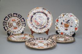 Six Royal Crown Derby plates, all of which are slightly different but all are in the Imari palette.