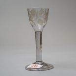 A plain stem wine glass with folded foot and plain stem decorated with pheasant vines