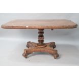 A William IV mahogany breakfast table having beaded edge, on snap hinge, turned column , platform