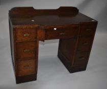 An early to mid 20th Century post Deco oak dressing table having ledge back (no mirror) , the