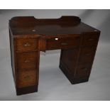 An early to mid 20th Century post Deco oak dressing table having ledge back (no mirror) , the