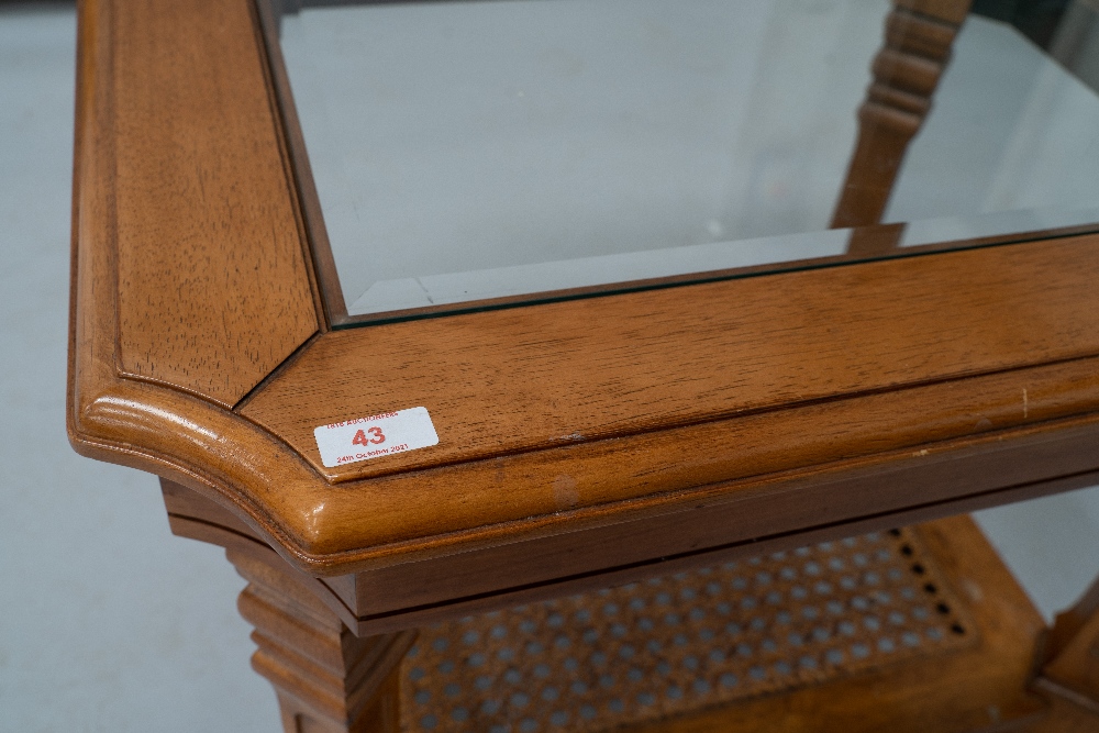 A modern stained frame coffee table having glazed top and bergere canework undertier, approx 68 x - Image 2 of 2