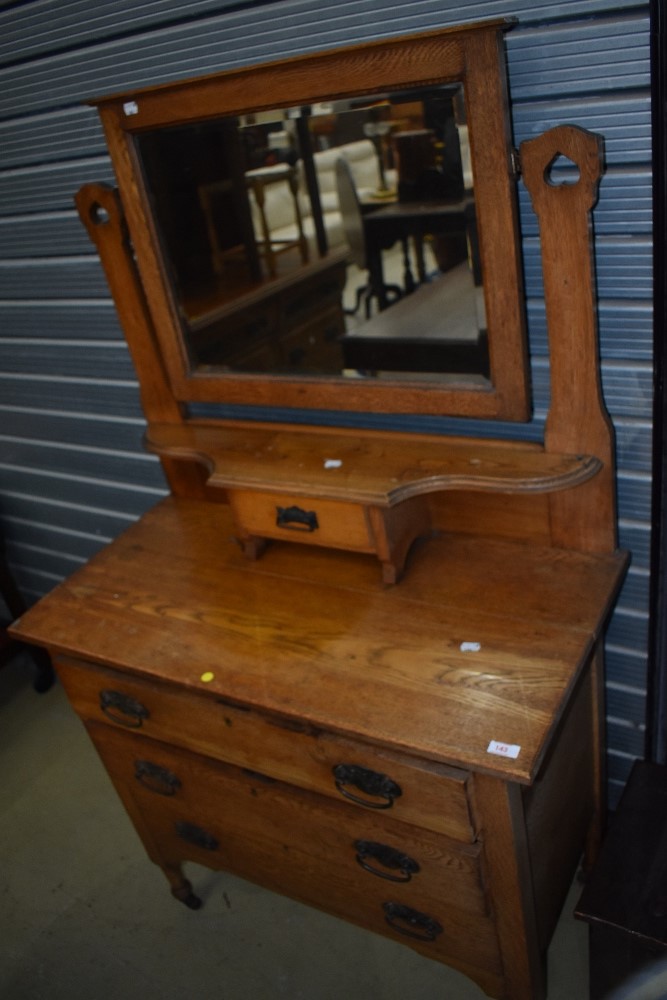 An Arts and Crafts golden oak dressing table having inverted heart motif to the mirror support ,