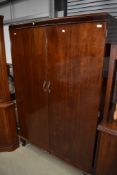 An early 20th Century mahogany double wardrobe having short cabriole legs , locked with no key,