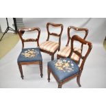 A set of four Victorian baloon back chairs having scroll rails, two with woolwork seats, two with