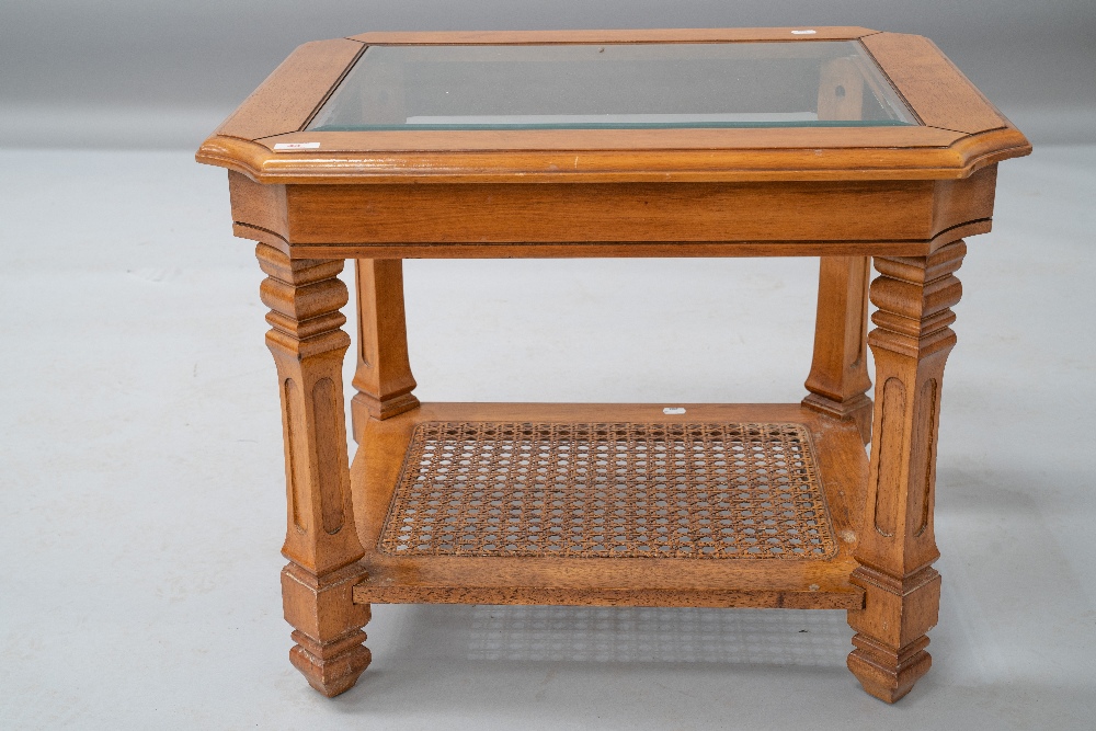 A modern stained frame coffee table having glazed top and bergere canework undertier, approx 68 x